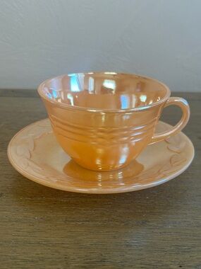 Vintage Fire King 1950-60’s Iridescent Peach Teacup and Saucer. Made in USA.